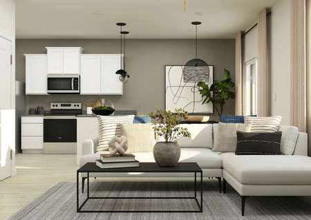 Rendering of a
  living room with a white sectional and a coffee table. The kitchen can be
  seen from behind the couch. 