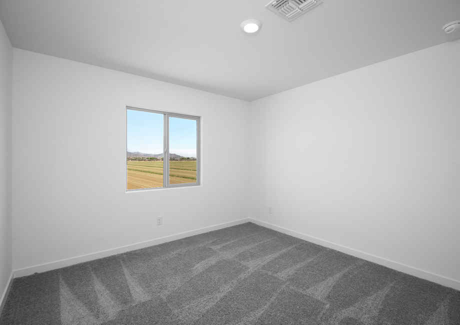 Windows let in plenty of light in this additional bedroom.