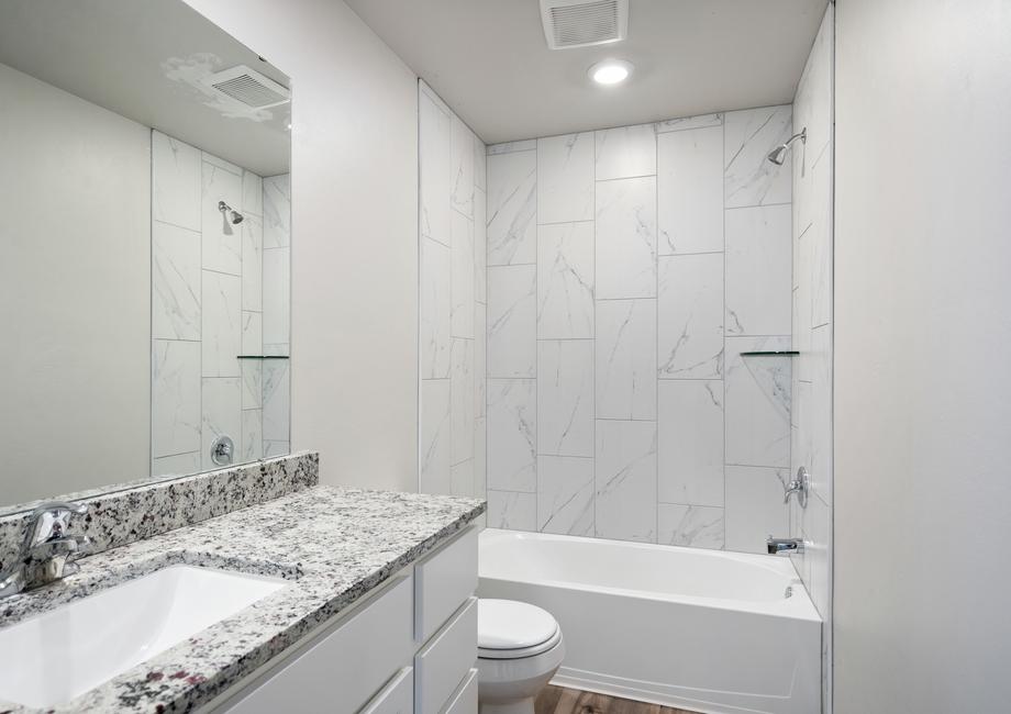 The secondary bathroom has a large shower-tub combo.