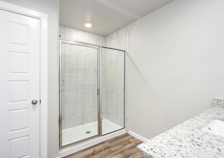 The master bathroom of the Coastal has a large glass, walk-in shower.