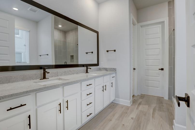 Master bathroom with two sinks and abundant storage space.