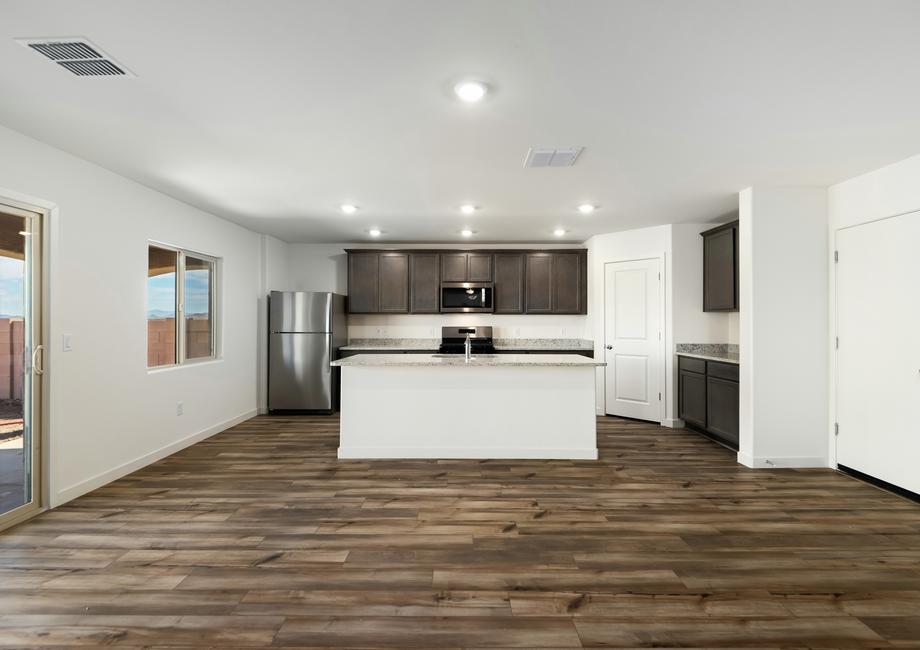 The kitchen has granite countertops and designer wood cabinetry