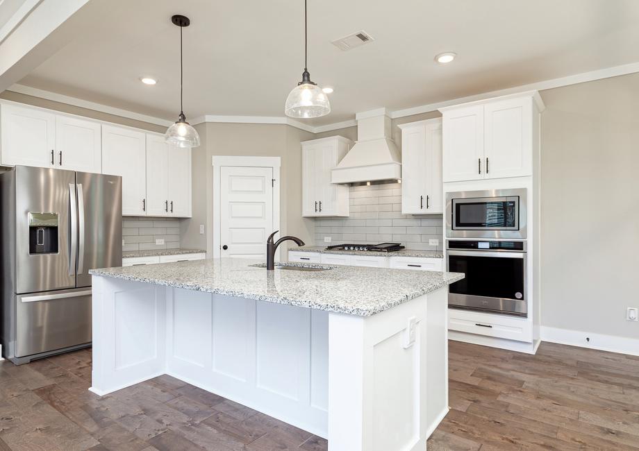 Kitchen with white cabinets and stainless appliances.