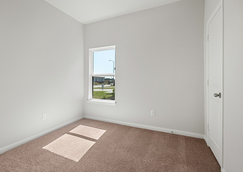 The second bedroom with lush carpet