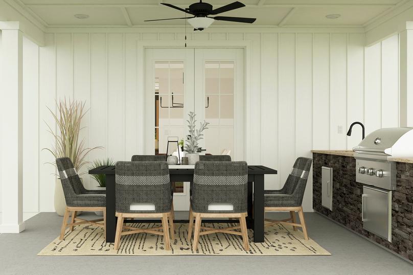 Rendering of outdoor patio with a large
  table next to an outdoor kitchen