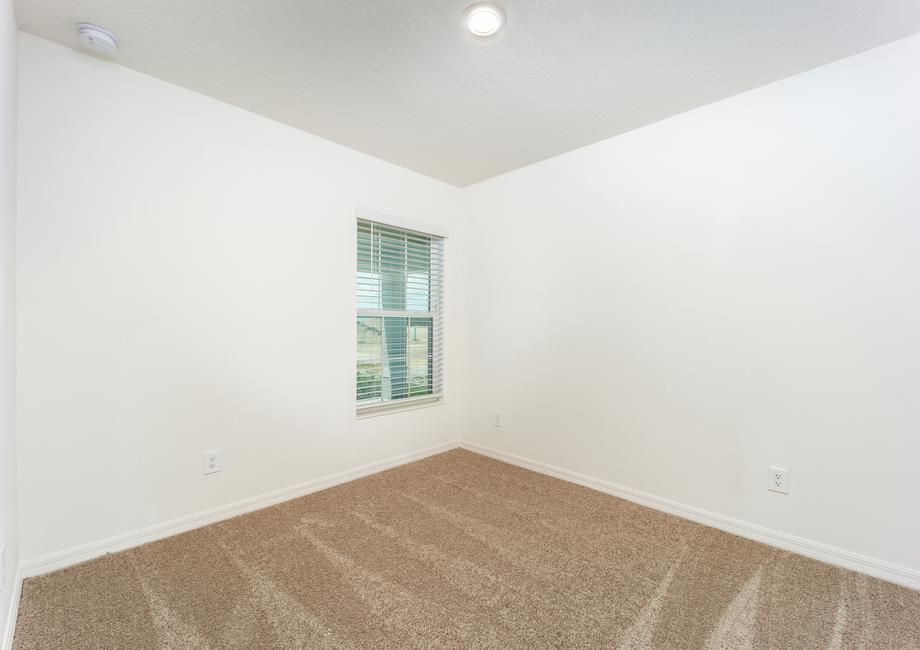 The second bedroom has a window that faces the front of the home