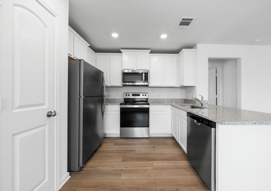 The chef ready kitchen features white cabinets and stainless steel appliances