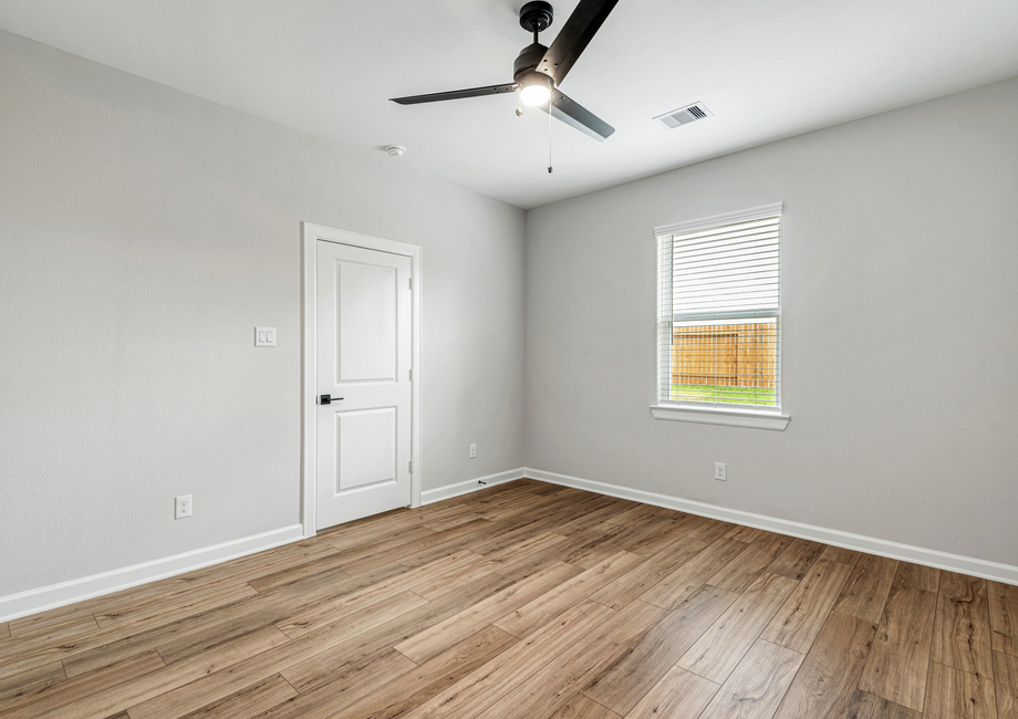 A spacious master bedroom with luxury vinyl flooring