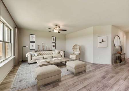 Rio Grande new home model completed with mid-century modern white colored sofa and ottomans, white Victorian era chair, and large light color throw rug