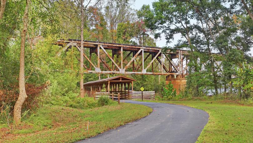 Riverwalk Trestle on the Piedmont Medical Center Trailwhere the railway bridge crosses the covered wooden walking bridge.