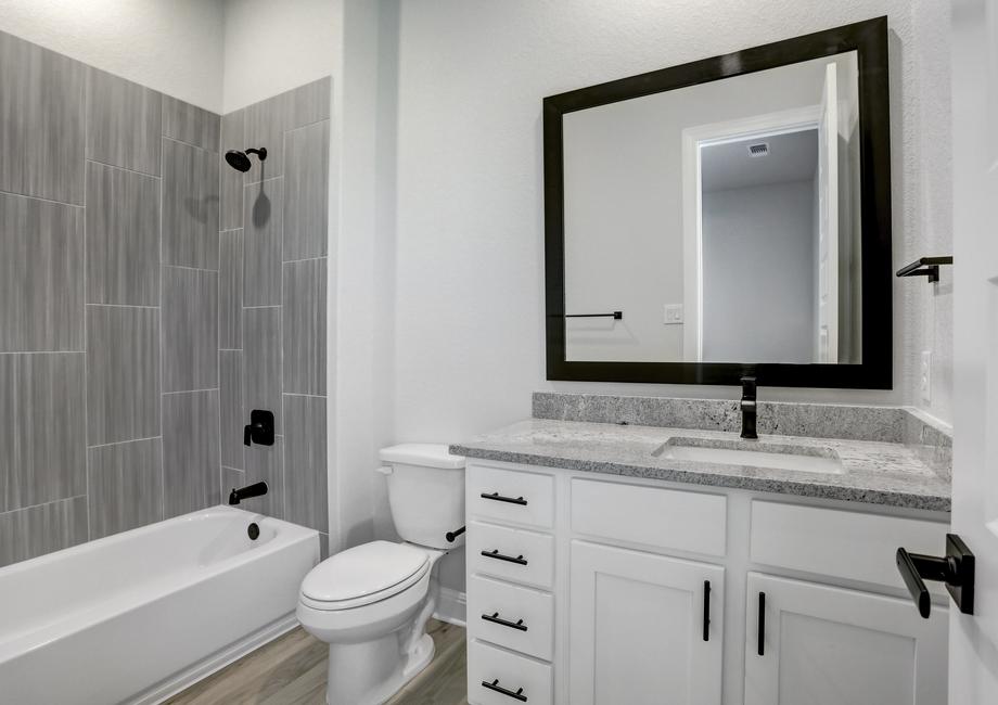 Secondary bathroom with extra drawers and storage space.