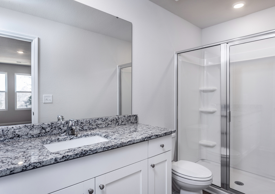 The master bathroom has a glass-enclosed shower