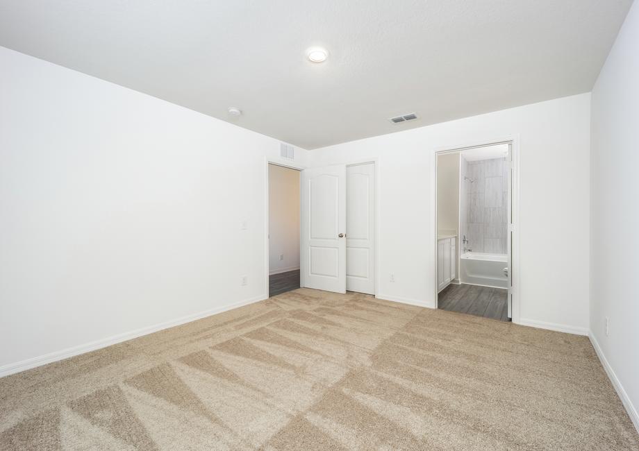 The master bedroom has its own walk-in closet and bathroom