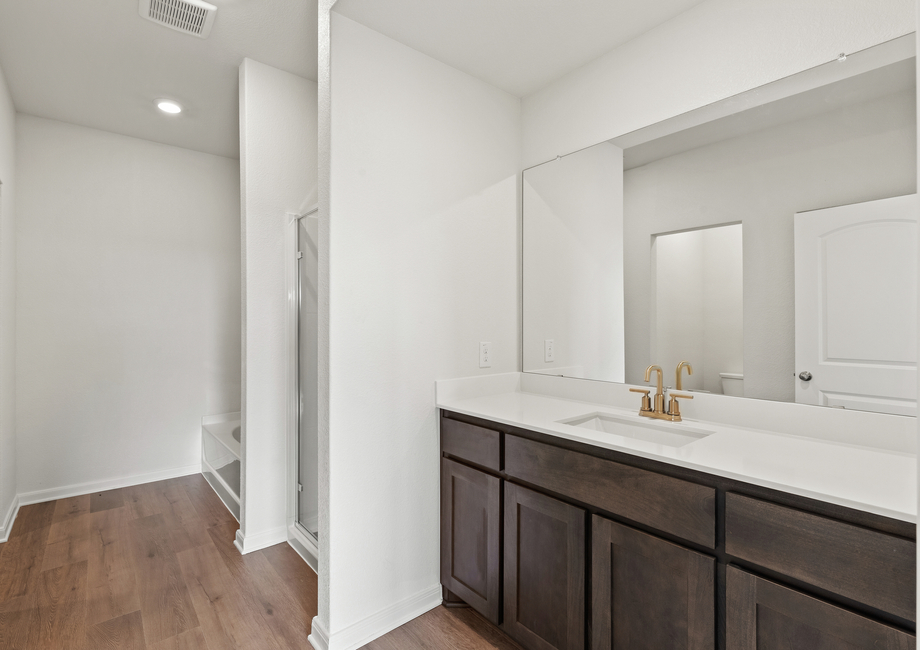 The master bathroom has a sprawling vanity space.