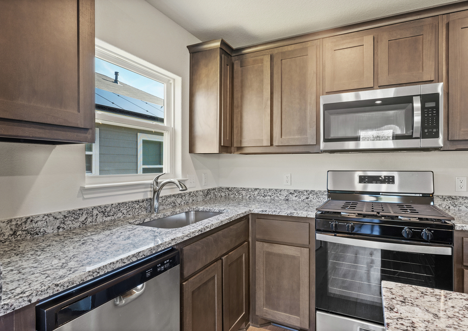 The kitchen has sprawling granite countertops.