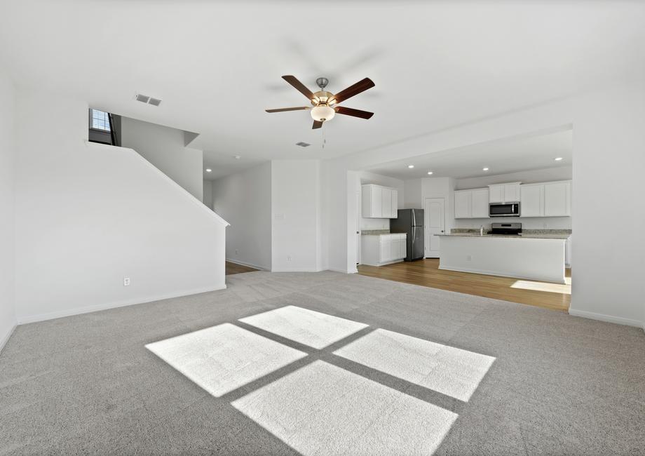 The spacious family room with carpet.