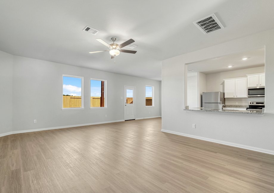 A breakfast bar overlooks the family room