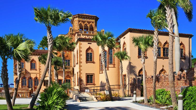 Sarasota, Florida Ringling Museum of Art mansion with yellow finish, brown accent paint, and numerous palm trees