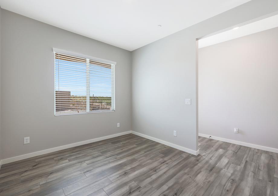 Dining room located off of the entry with large windows and wood-style flooring.