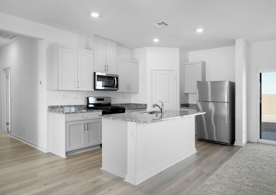 The kitchen is chef ready and has stainless steel appliances and plank flooring.