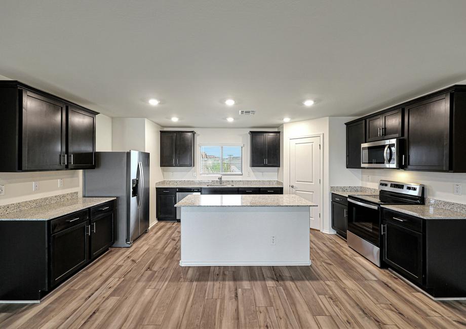 Enjoy stunning granite countertops and designer wood cabinetry in this kitchen.