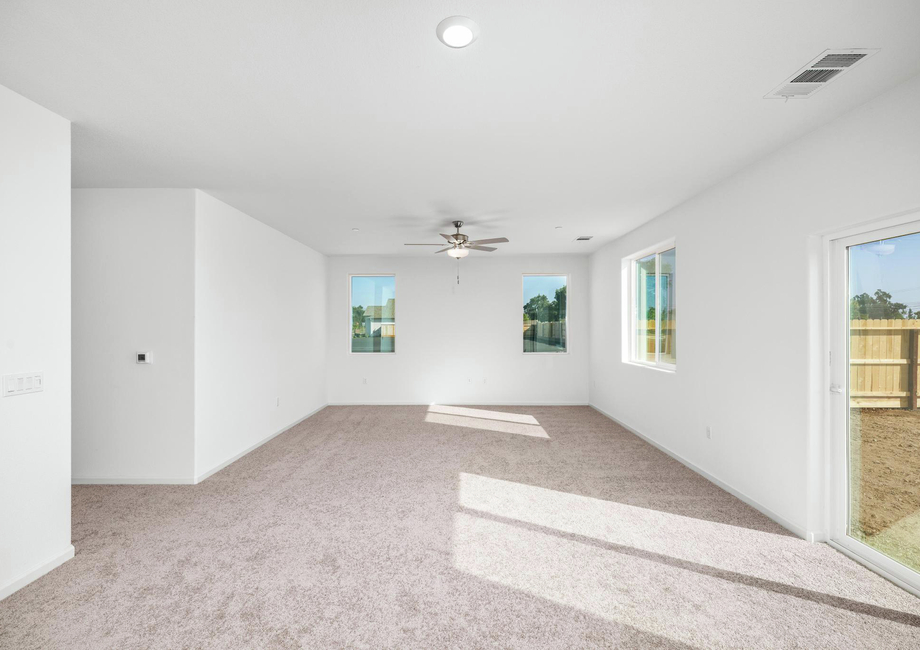 The family room is spacious with a ceiling fan.