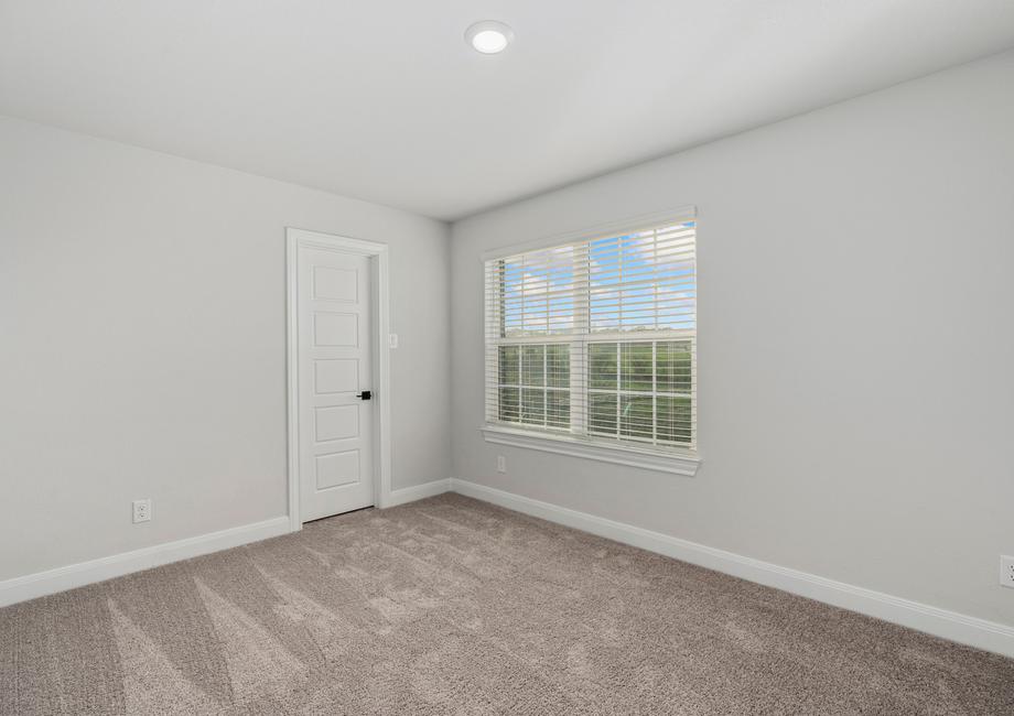 Secondary bedroom with large windows and a large closet.