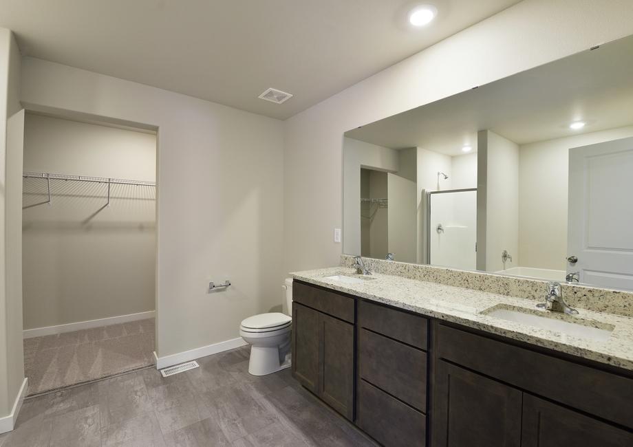 The master bathroom has a large dual vanity.