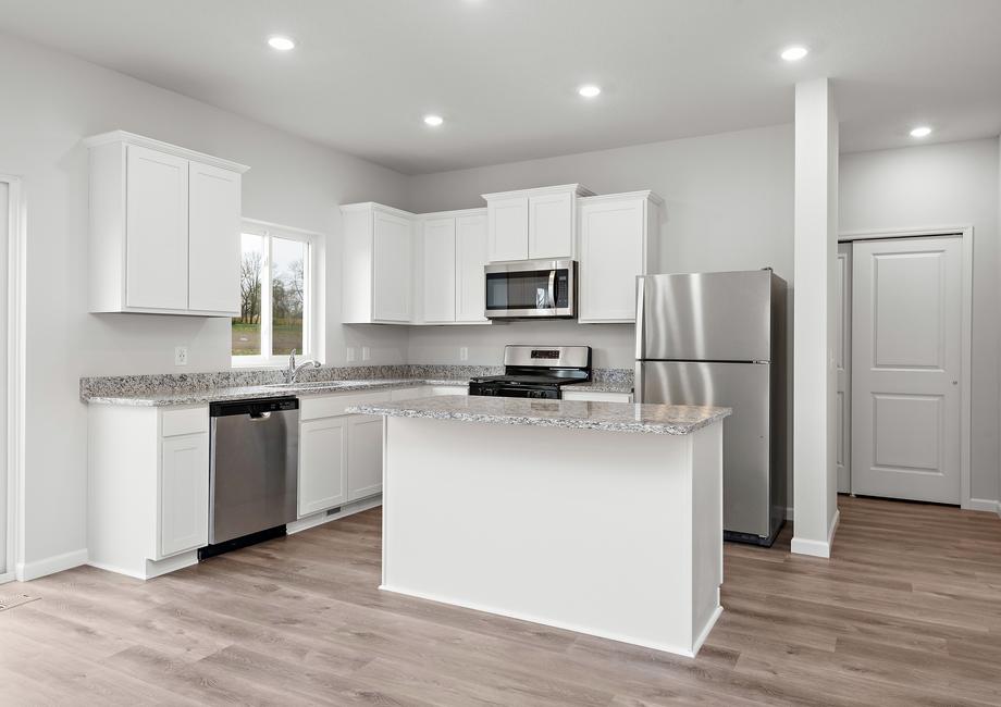 The kitchen has stainless steel appliances and plank flooring.