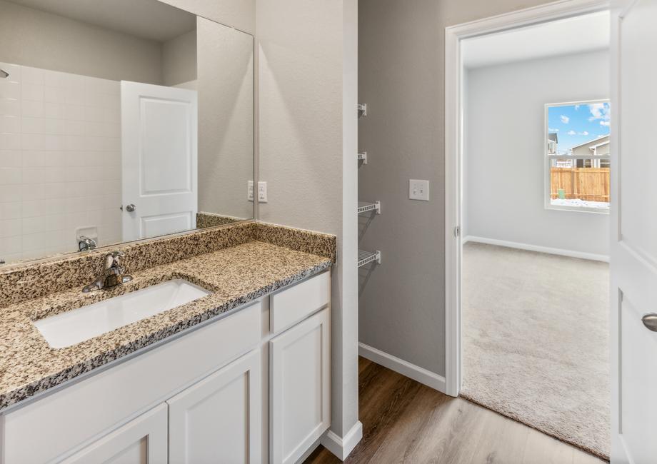 Master bathroom has a vanity with plenty of counterspace.