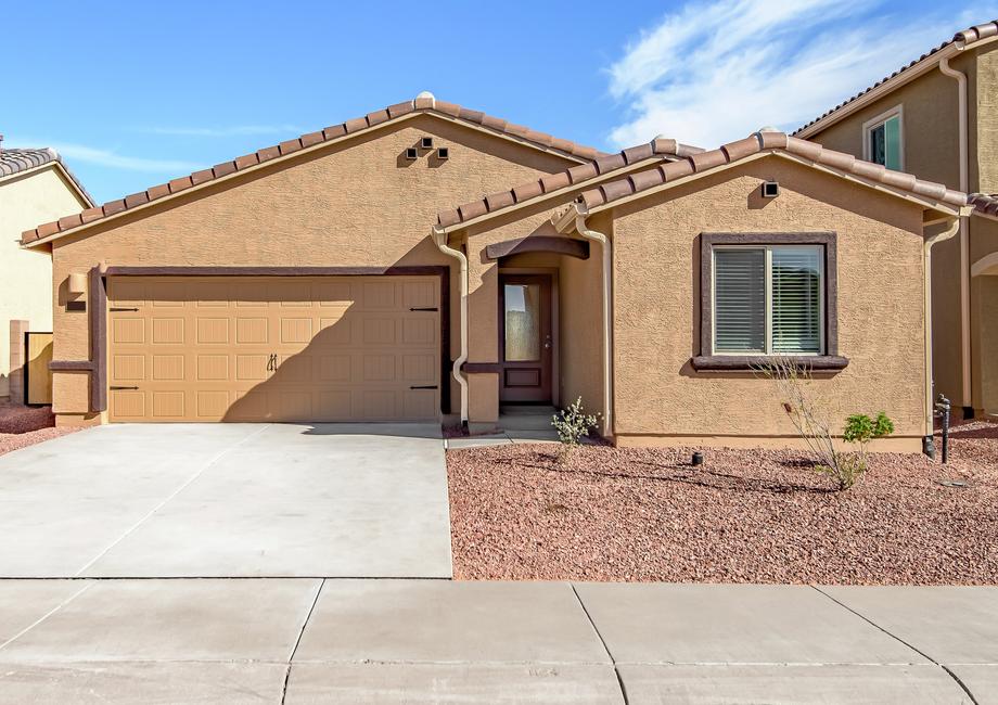 The Ash by LGI Homes has a stucco exterior and a two-car garage.