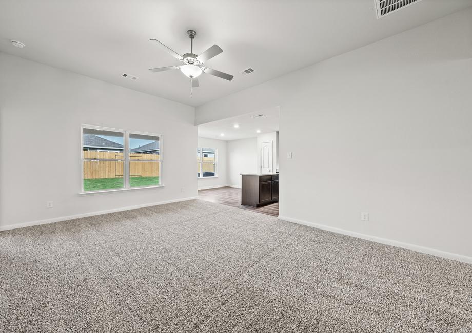 The family room has large windows that provide a great view of the fully-fenced backyard.