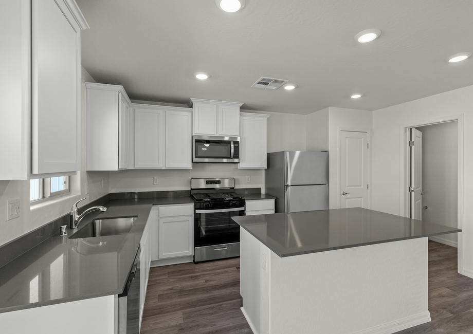 The kitchen of the Cypress has white wood cabinetry.