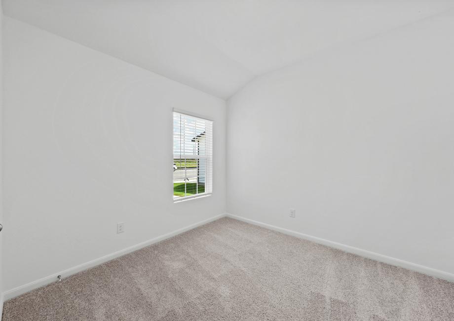 A bedroom with lush grey carpet