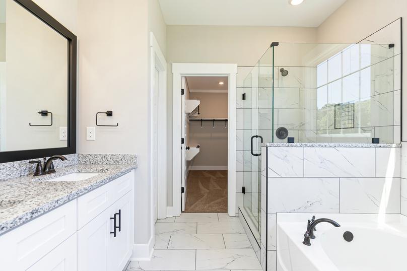 Master bathroom with large vanity and a walk-in shower.
