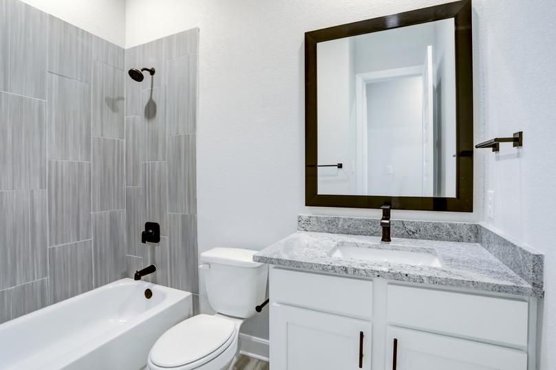 Secondary bathroom with a tile-lined dual shower and tub.