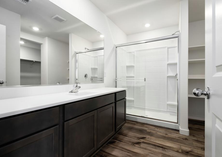 The bathroom has a glass-enclosed shower.