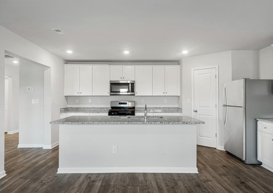 The chef ready kitchen has stainless steel appliances and white cabinets.