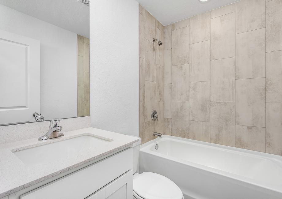 The second bathrooms has gorgeous tile detail in the tub.