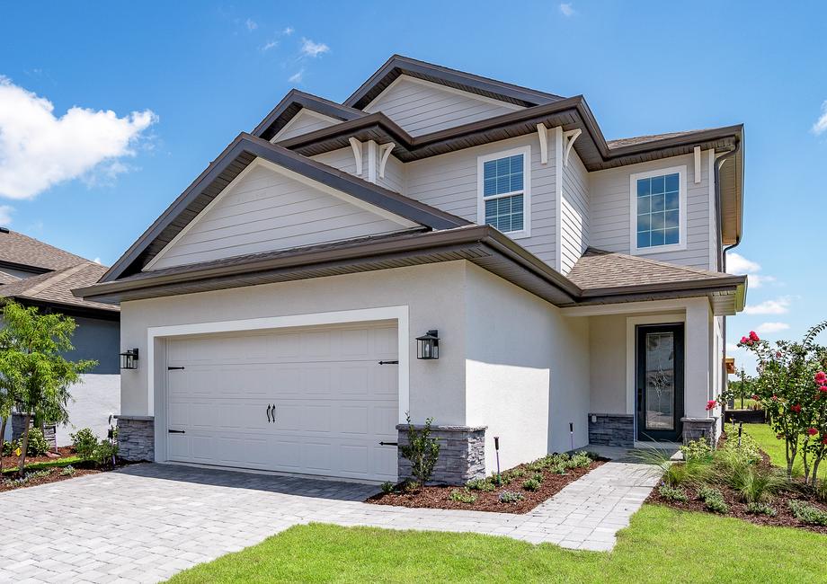 Two-story home showcasing a two-car garage.