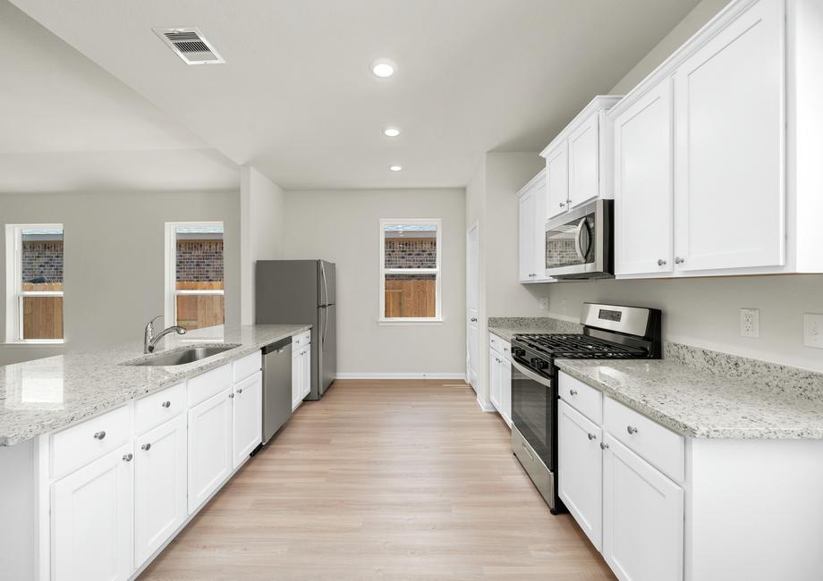 Chef ready kitchen with white cabinets and granite countertops