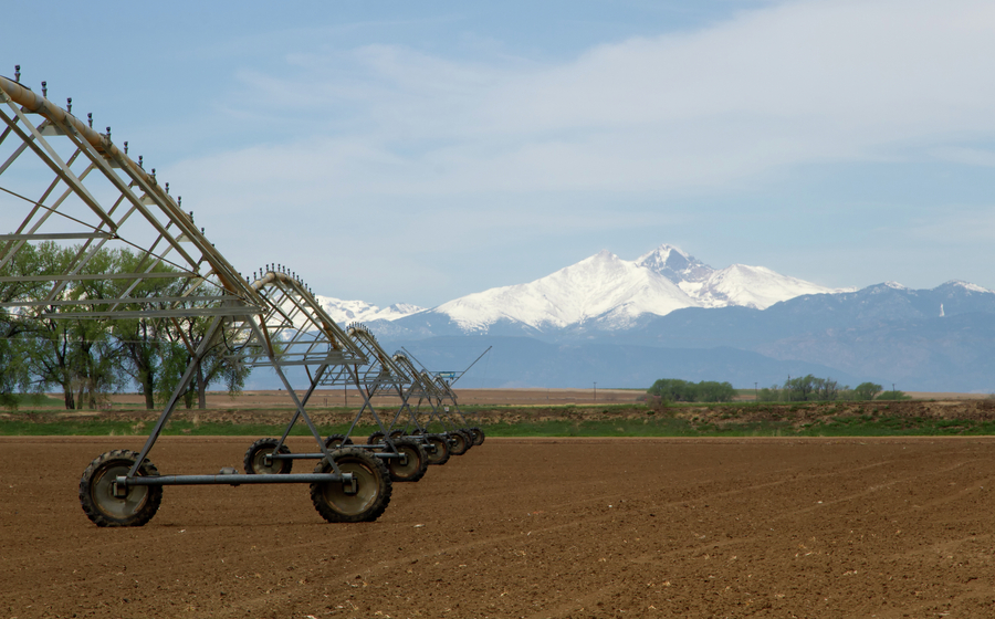Pivot Irrigation System in an agriculture field with Longs Peak in the background stock photo