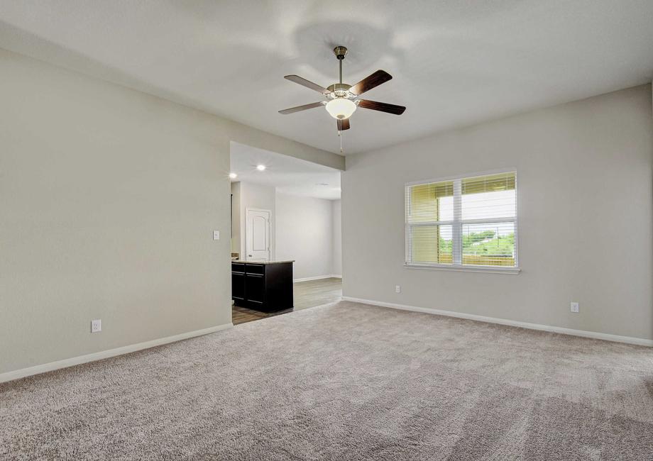 Crockett finished home plan with light gray carpet, gray walls with white trim, and overhead ceiling fan with light.