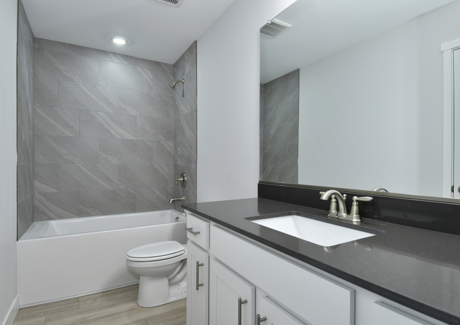 The secondary bathroom has a tub shower combo.