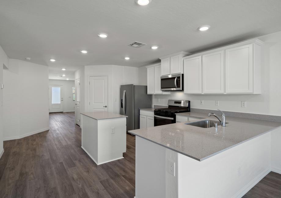 The chef ready kitchen has a plank flooring and stainless steel appliances!