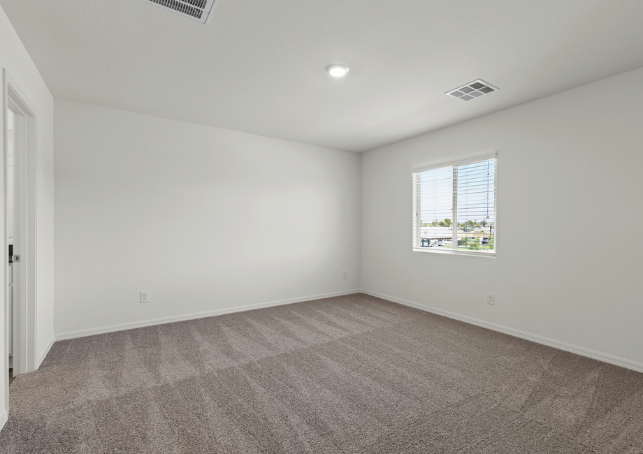 The spacious master bedroom has a wonderful window that lets in great, natural light.