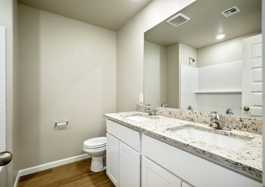 This guest bathroom features dual-vanity sinks.