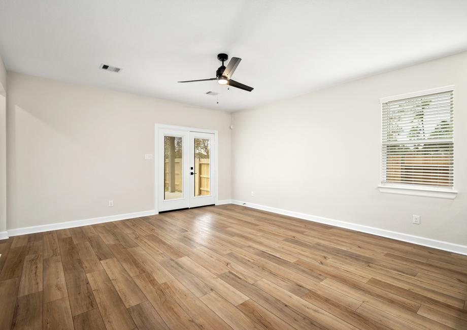 The spacious family room has double doors that lead to the back patio