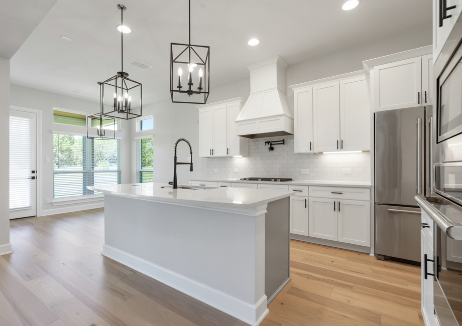 The kitchen has beautiful white cabinets.