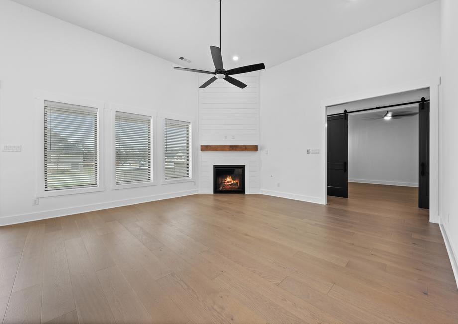 The spacious family room has large windows and an electric fireplace.